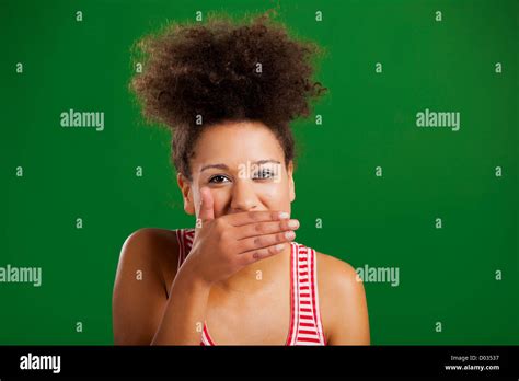 Beautiful African Woman Laughing Over A Green Background Stock Photo