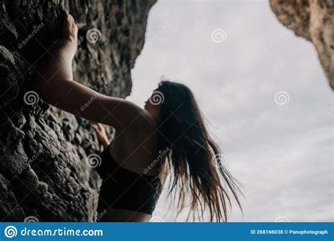 Sports Woman Climbing The Rock Young Woman With Slim Fit Body Climbing In Volcanic Basalt Cave