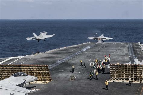 Laminated Poster Fa 18s Launch From The Flight Deck Of The Us Navys