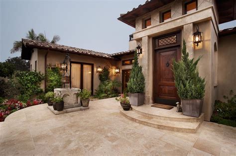 Italian Villa Front Entry Courtyard With Neutral Stone Tile Leading To