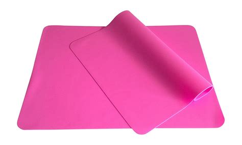 Pink Yoga Mat Rolled Up On Top Of Each Other With A Roll Of Paper Next