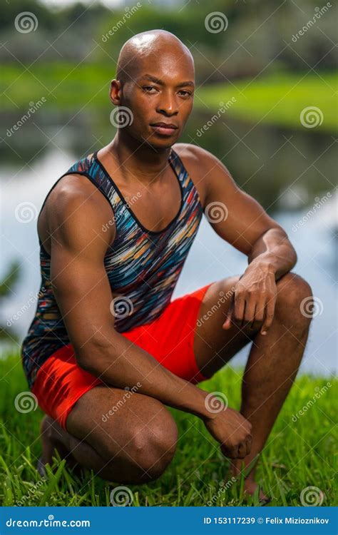 Portrait Of A Handsome Young Man In A Squatting Post Stock Image