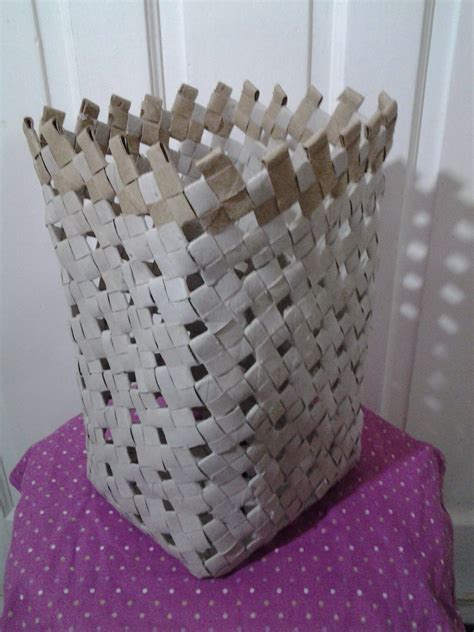 A Woven Basket Sitting On Top Of A Purple Table Cloth Next To A White Door
