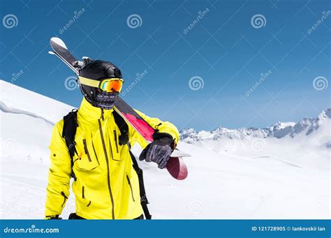 Skier Standing On A Slope Man In A Light Suit The Helmet And Mask In