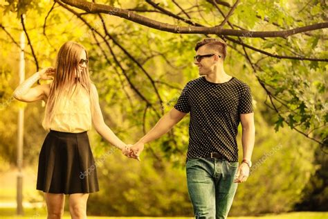 Couple Taking Walk Through Park Stock Photo By ©voyagerix 109443002