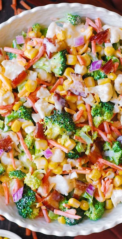 A Bowl Filled With Corn Broccoli And Other Vegetables On Top Of A Table