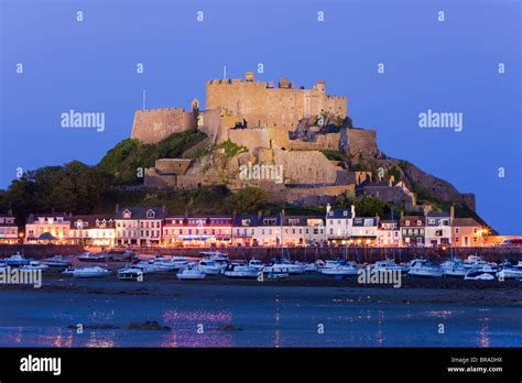 Mount Orgueil Castle Illuminated At Dusk Overlooking Grouville Bay In