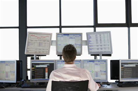 Stock Trader Looking At Multiple Computer Screens Stock Photo Image