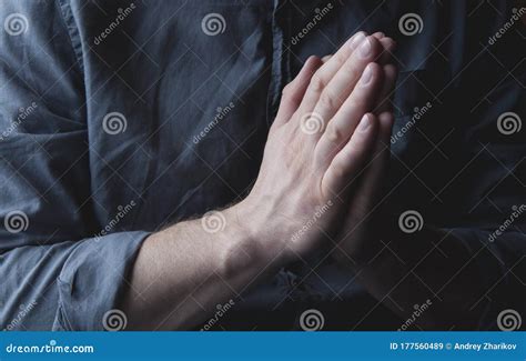 Clasped Hands In Prayer Asks God Hands Of A Man In A Shirt A Man Is