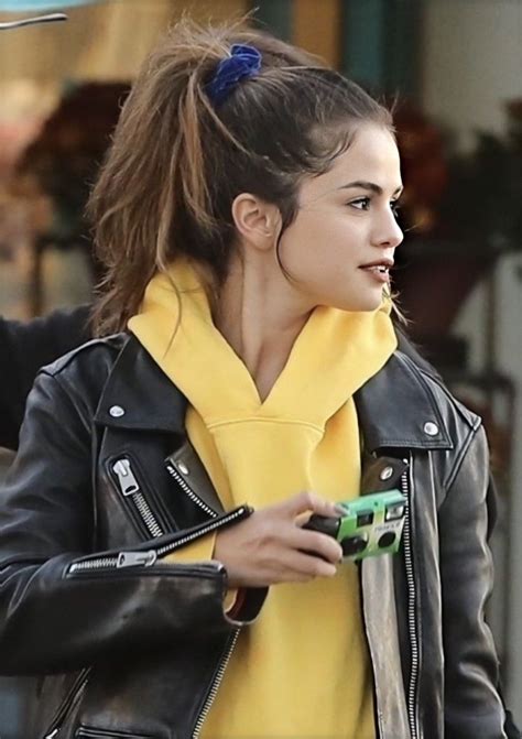 A Woman In A Black Leather Jacket And Yellow Scarf