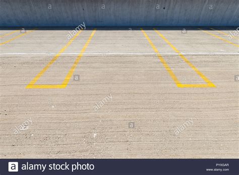Empty Parking Spaces With Yellow Lines In A Parking Garage Stock Photo