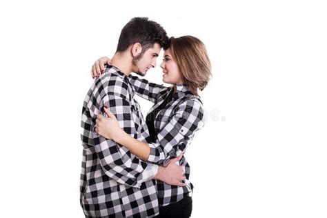 Happy Young Couple Embracing Each Other And Kissing Isolated On White