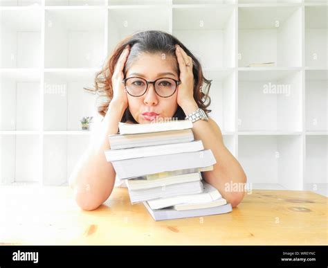 Young Female Asian Student With Books Studying In Library Hi Res Stock