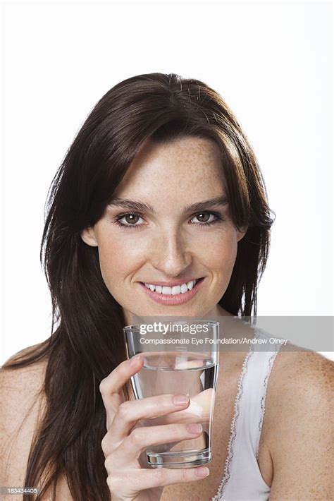 Close Up Of Smiling Woman Holding Glass Of Water High Res Stock Photo