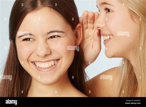 Teenage Girls Whispering To Each Other Stock Photo Alamy