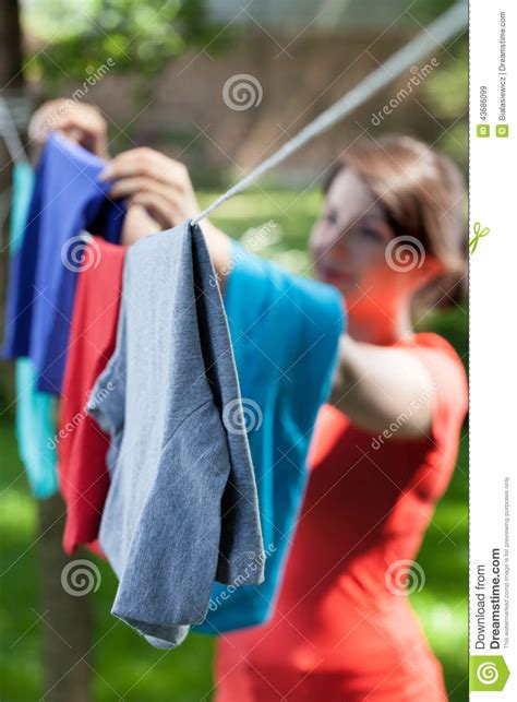 Woman Hanging Clothes On Laundry Line In Garden Stock Image Image Of