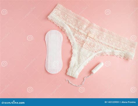 women intimate hygiene products sanitary pads and tampon near womans panties on pink