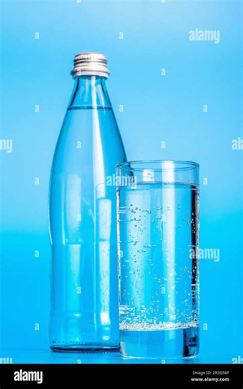 Glass Water Bottles On A Light Blue Background Stock Photo Alamy