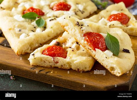 Traditional Italian Focaccia With Rosemary Tomatoes And Feta Close Up Homemade Flat Bread