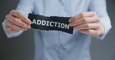 Dealing With Addiction A Woman Shows A Label Reading Addiction And