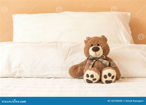 Brown Teddy Bear Sitting Alone On The Bed Stock Photo Image Of
