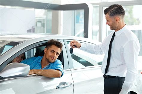 Hand holding keys with modern building on background. Car Salesman Handing over new Car Key to Customer — Stock ...