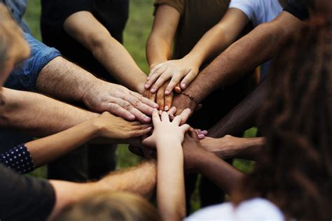 Group Of People With Their Hands Together Circle Of Care