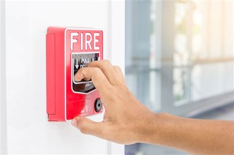 Premium Photo Hand Of Man Pulling Fire Alarm Switch On The White Wall