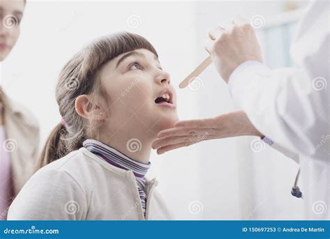 Doctor Checking A Girl`s Throat During A Visit Stock Image Image Of