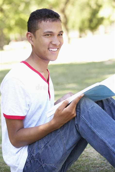 Teenage Boy Sitting In Park Reading Stock Photo Image Of Vertical