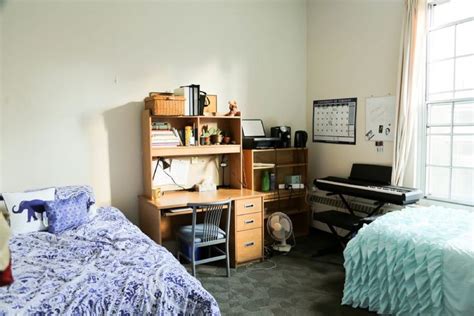 a bedroom with a bed and desk in it