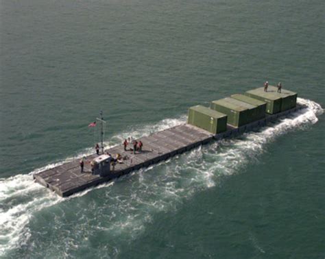 A Us Army Modular Causeway System Transports Equipment From The Usns