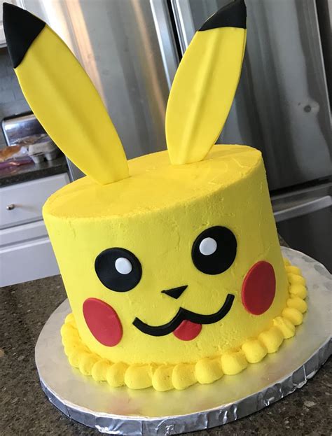 A Yellow Cake Decorated Like A Pikachu With Ears On Its Head