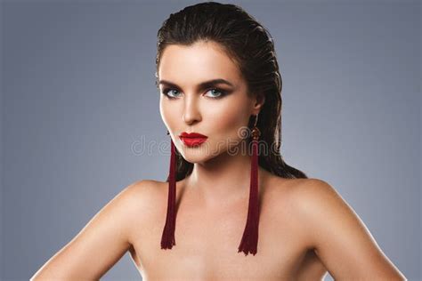 stunning woman with a beautiful makeup wearing long red earrings stock image image of makeup
