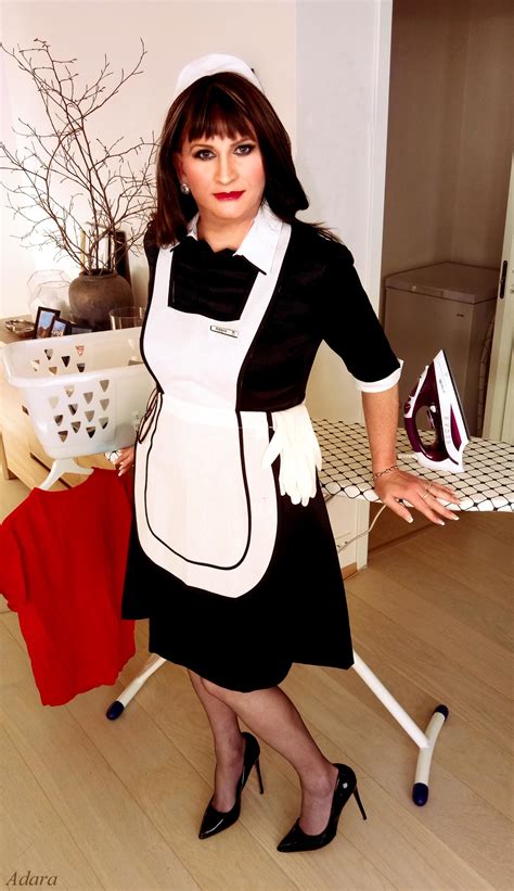 A Woman Dressed In An Apron And Dress With Her Hands On The Ironing Board