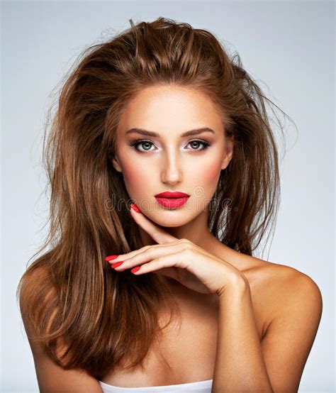 Face Of Young Woman With Red Nails Lipstick And Long Brown Hair Model