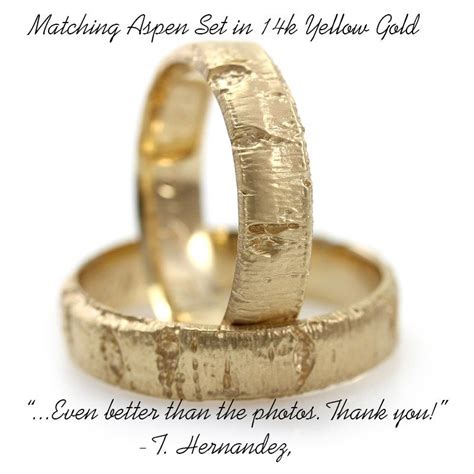 Two Gold Wedding Rings Sitting On Top Of Each Other