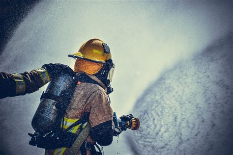 Fireman Holding Fire Hose · Free Stock Photo