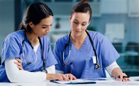 Two Nurses Talking Stock Photos Pictures And Royalty Free Images Istock