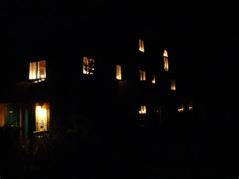Looking Through The Mosswood House Windows At Night Aglow With Golden