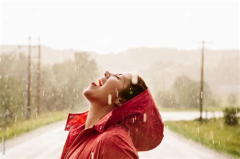 Woman Catching Rain Drops In Her Mouth By Shaun Robinson Stocksy United