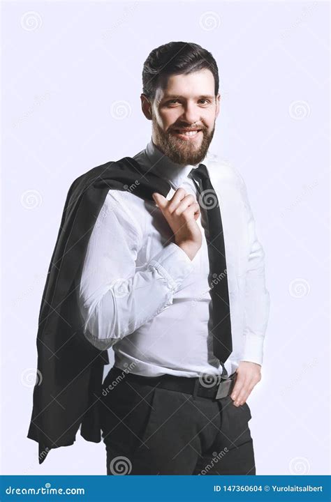 Smiling Businessman Holding A Jacket Over His Shoulder And Straightens