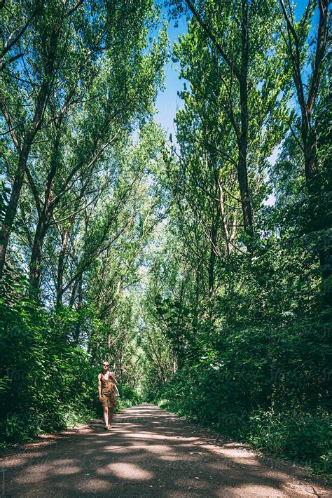 Woman In The Park On Summer Nature Walk Del Colaborador De Stocksy