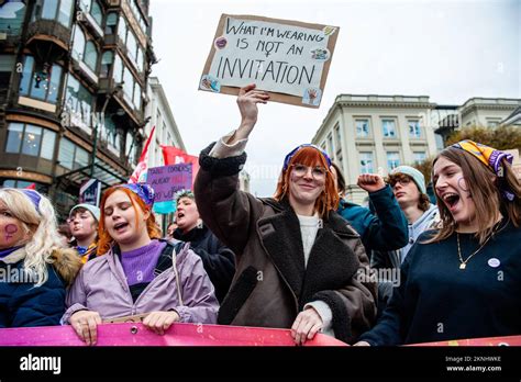 a woman is seen holding a placard against the harassment of women