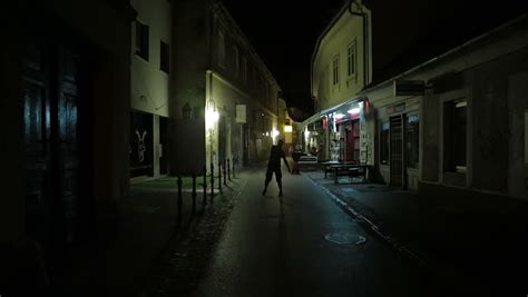 Walking Down The Street On Halloween Night Mp3 - Guy Walking Through The Street By Night Acting Like Zombie Stock