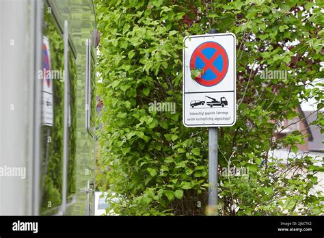 german sign not allowed to part and that parking cars will be towed away reflection of the