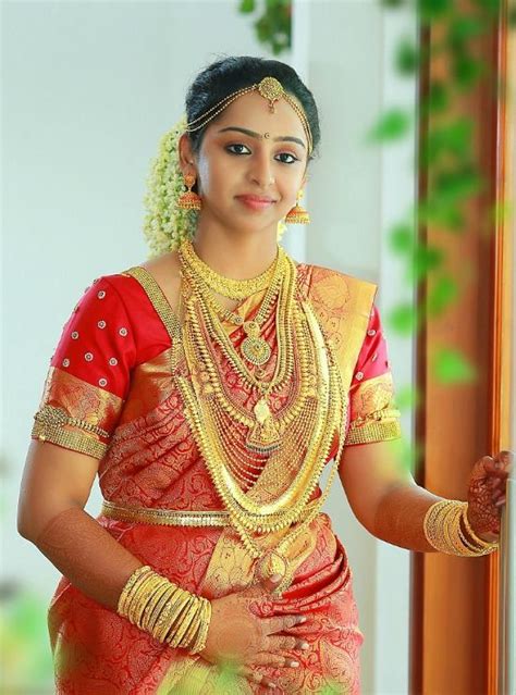 Kerala Bride Wearing Red Wedding Saree Paired With Sequins Work Blouse