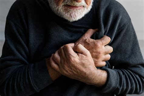 Closeup Of Elderly Man Having Heart Attack Chest Pain Stock Photo