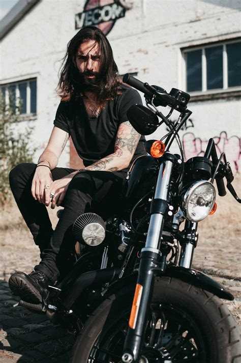 Man Sitting On Black Cruiser Motorcycle Photo Free Motorcycle Image