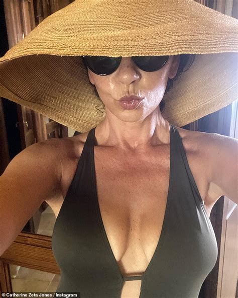 Catherine Zeta Jones Puts On A Busty Display In A Plunging Khaki